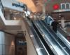 man slides down escalator railing but trips and falls, fail