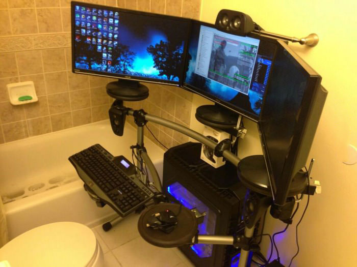 gaming throne, three screen gaming computer system in front of toilet