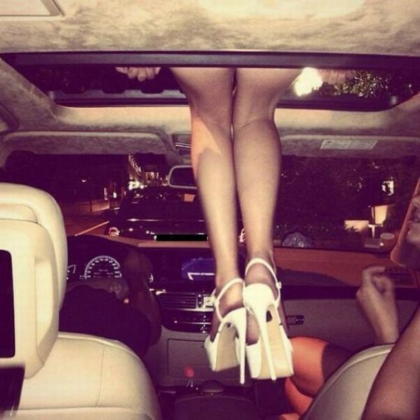 just the some legs hanging down from a car's skylight