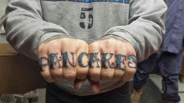 tattoo of the word pancakes across two hands