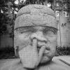 just an actual stone face sculpture of a guy picking his nose