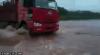 truck powers over flooder highway only to get pulled under where the road caved and gave way, fail