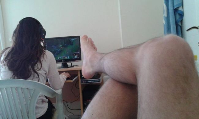 girl playing video games in front of bare legs