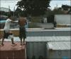 horizontal motion back flip form one shipping container to another, friend pushes backflipping friend