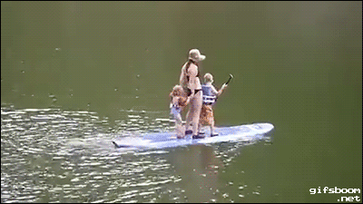 family on paddle board fall into water backwards, fail