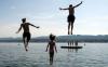 three kids jumping into the water