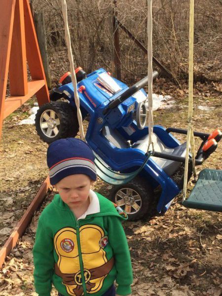 little boy wearing teenage mutant ninja turtle hoodie sad about his truck accident