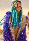natural born raver, really colourful rave girl with purple jacket green and teal dreads and ski goggles