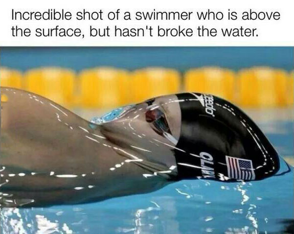 incredible shot of a swimmer who is above the surface but hasn't broke the water