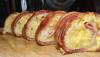 this breakfast sushi is filled with tater tots eggs and it is wrapped in bacon, for porn