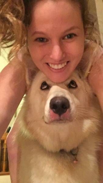 girls takes selfie with dog and dog is embarrassed