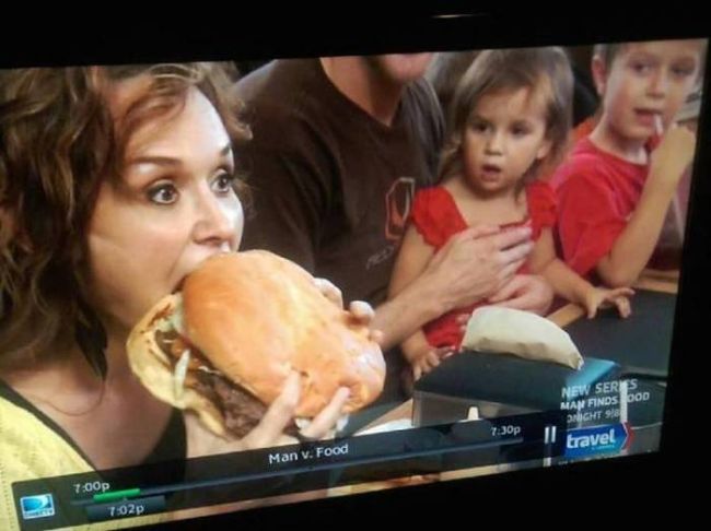 woman eating giant hamburger on man vs food, little girl's reaction is priceless