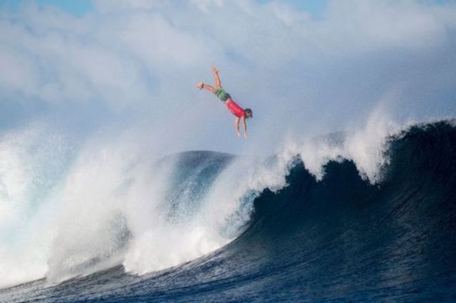 surfer tossed into the air by a large wave