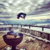 backflip off a fence with two huskies and glorious mountains on the horizon