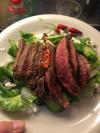 this is what a real salad looks like, rare steak slices on vegetables