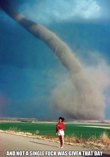 and not a single fuck was given that day, girl posing in front of huge tornado