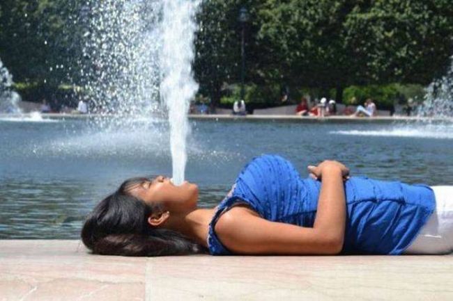 girl vomiting a fountain of water, perspective shot