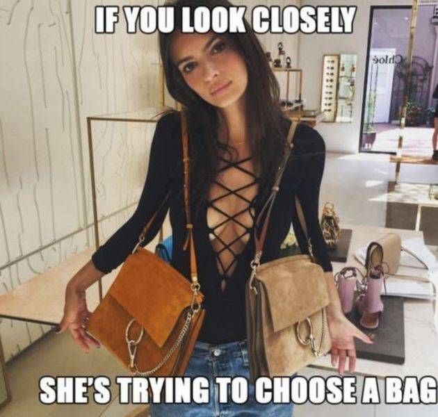 if you look closely she's trying to choose a bag, meme