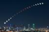 composite image showing the moons transition from full moon over downtown dallas texas