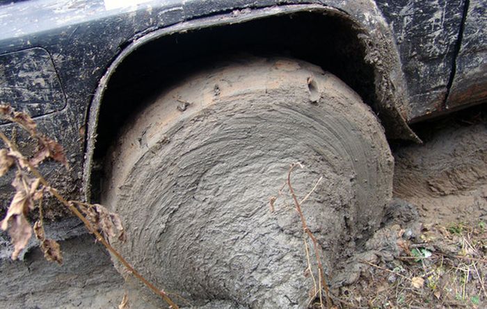 truck wheel completely covered in mud