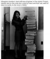 margaret hamilton, lead software engineer of the apollo project,  stands next to code wrote by hand and that was used to take humanity to the moon in 1969