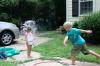 perfectly timed water balloon explosion, siblings have a water fight