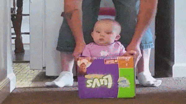 baby reacting to top speed of his new cardboard box go kart