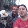 two canadian guys take a selfie with a bald eagle