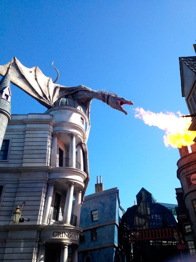 dragon gargoyle on building blows fire, epic architecture