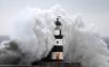 huge wave hitting lighthouse