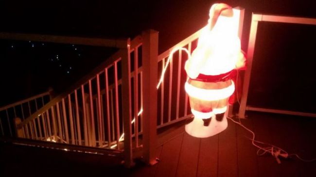 santa claus decoration pissing down the stairs