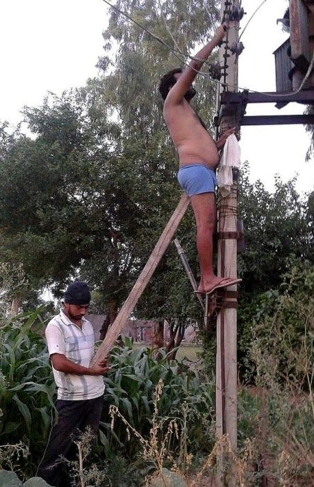 helping your friend fix the power line with a wooden ass support