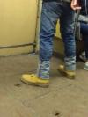 reversed jeans ends over boots, poorly dressed