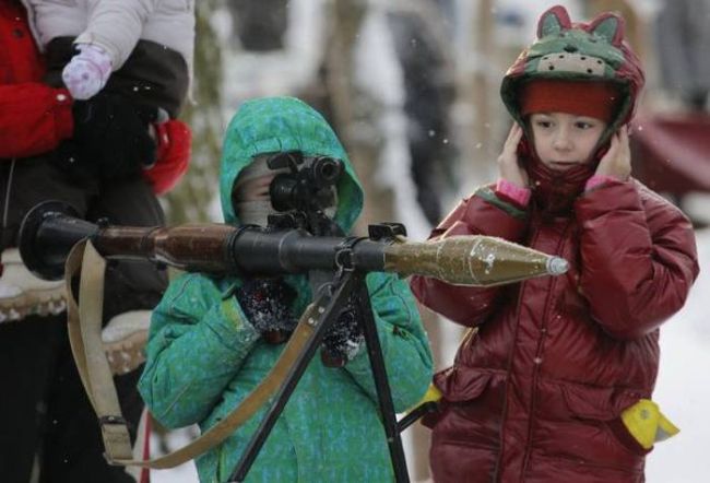 beware of isis' new young recruits, little girl holding rocket launcher