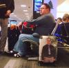 fat guy has picture of self on luggage