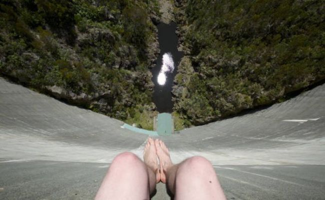 sitting at the top of a dam