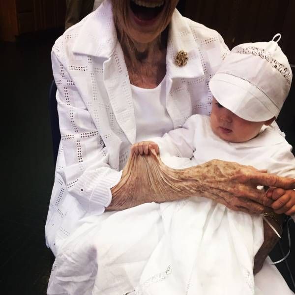 baby pulling on great grandmother's skin