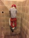 little boy peeing in urinal by standing on it