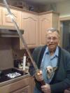 old guy with cigar holding a sword with angry chihuahua in shirt, wtf