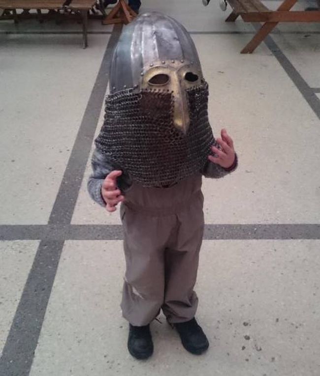 kid wearing medieval knight helmet