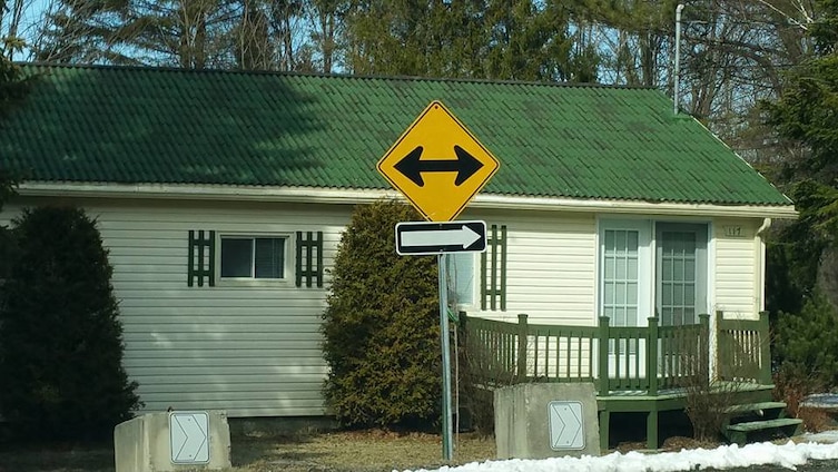 contradictory street signs, turn either way on this one way street