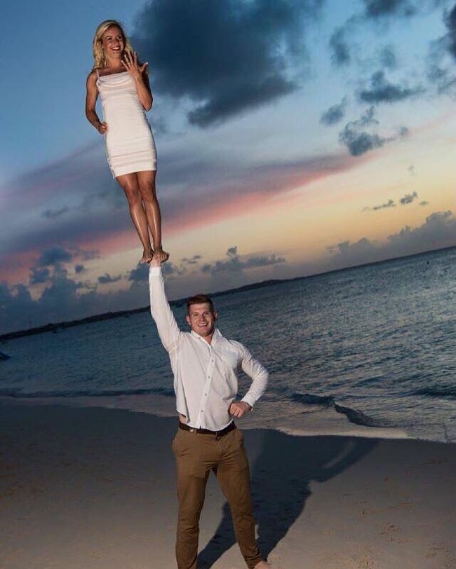 when you're married and you feel really high, husband holding wife up above his head with one arm