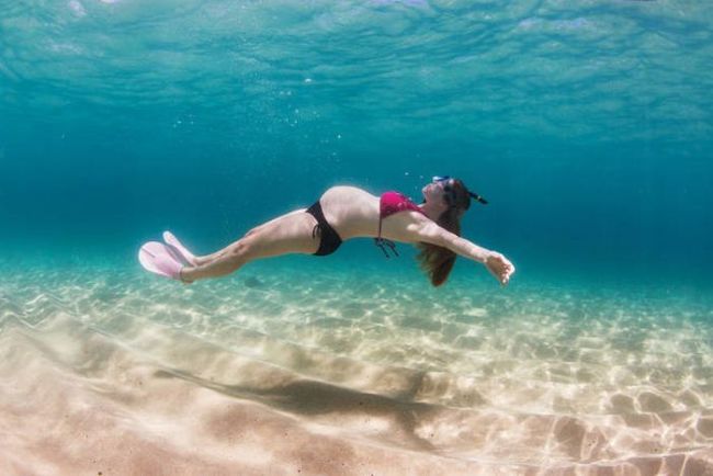 pregnant woman floating underwater