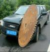 giant saw blade stuck in front of car, accident