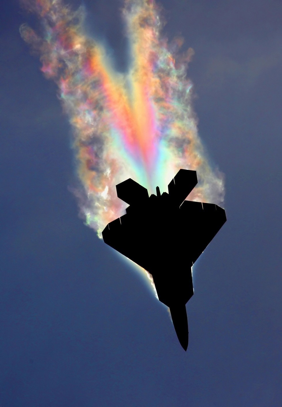 rainbow in wake of supersonic fighter jet