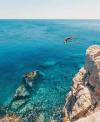 back flip off cliff into crystal clear blue ocean water, nature is beautiful