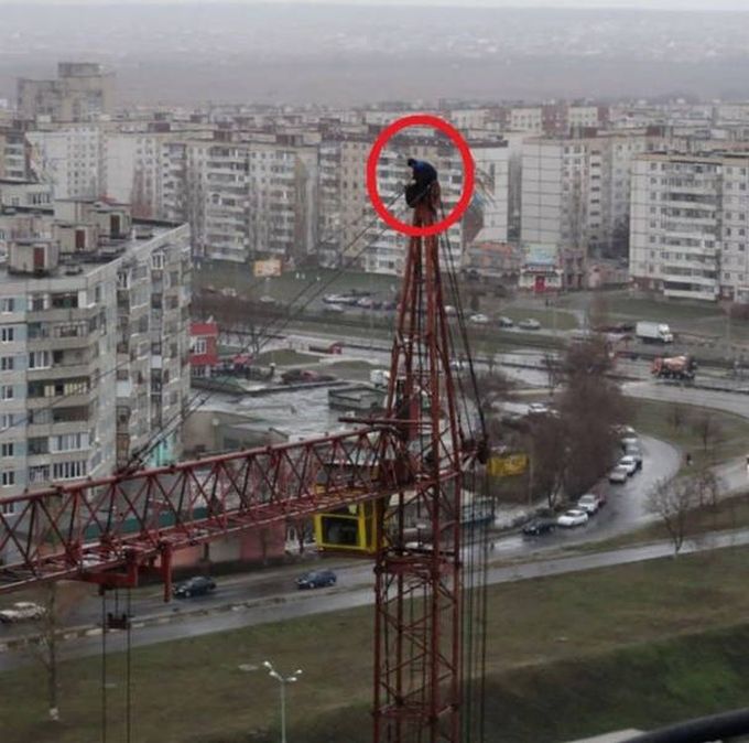man working on top of fixed crane