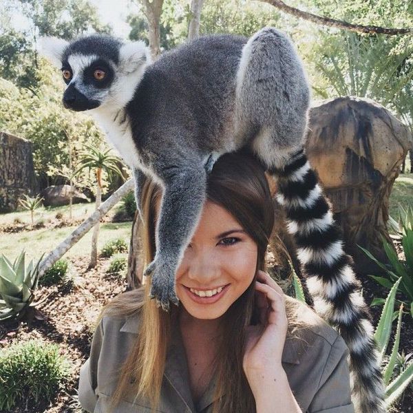 happy lemur is happy on hot girl's head