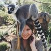 happy lemur is happy on hot girl's head