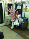 asian man with epic toys on the subway